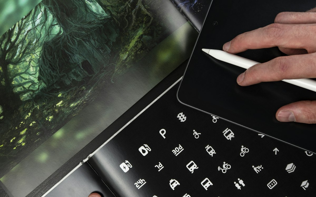 A person editing an image on a digital tablet with a stylus.