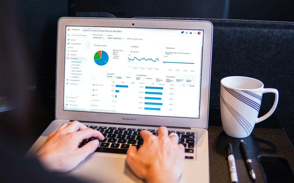 A person reviewing an analytics dashboard on a laptop.