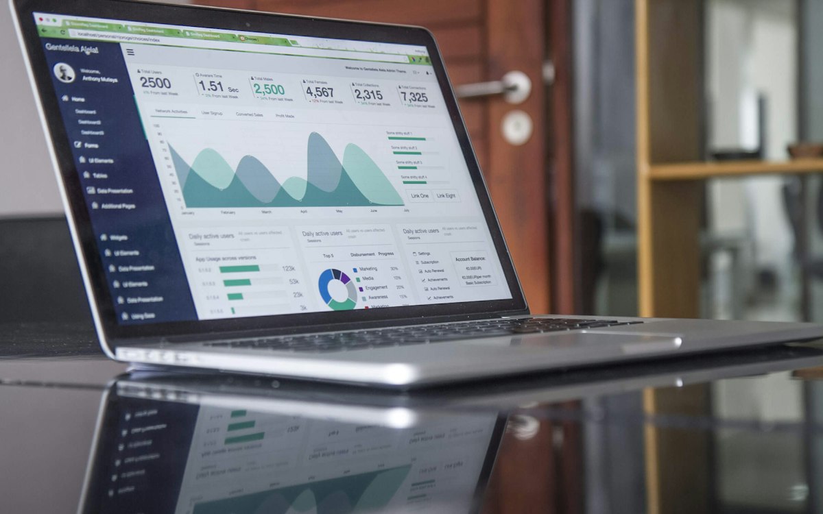 A laptop displaying website traffic charts.