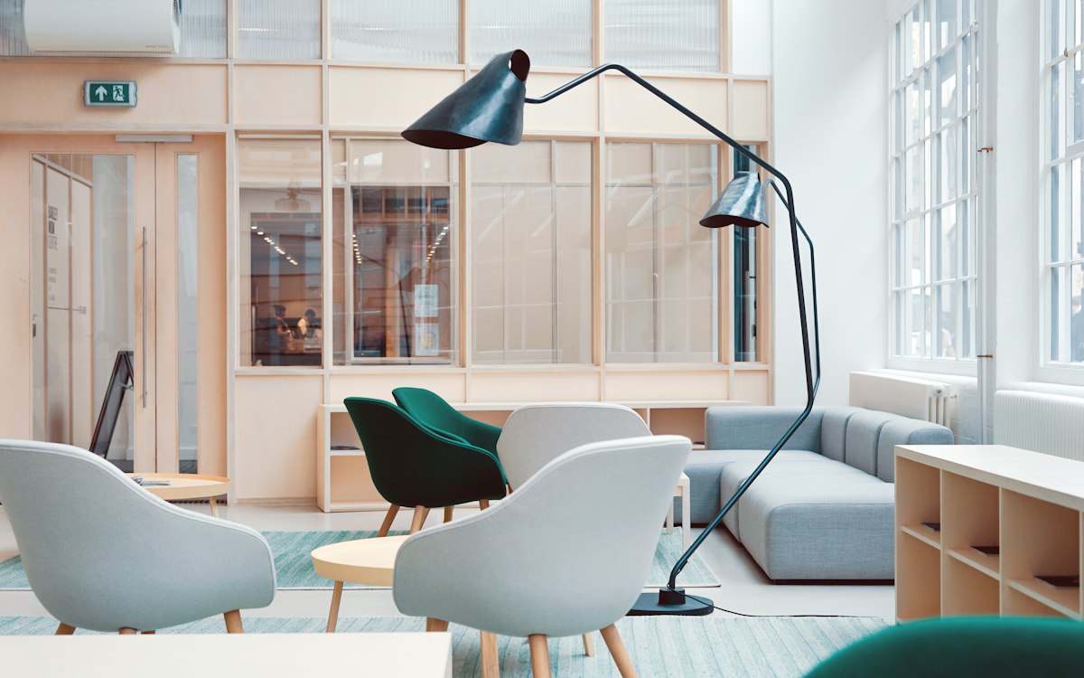A light-filled shared workspace with comfortable seating.
